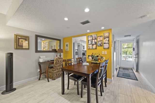 dining space with a textured ceiling