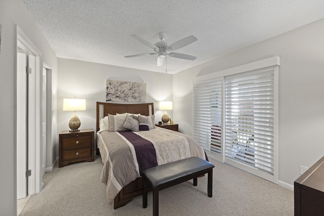 carpeted bedroom featuring access to exterior, ceiling fan, and a textured ceiling