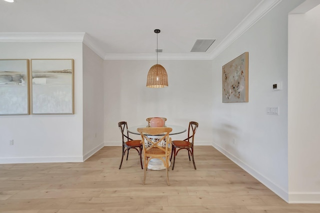 dining space featuring light hardwood / wood-style flooring and ornamental molding