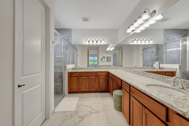 bathroom featuring vanity and a shower with shower door