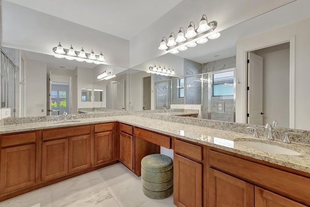 bathroom with vanity and a shower with door