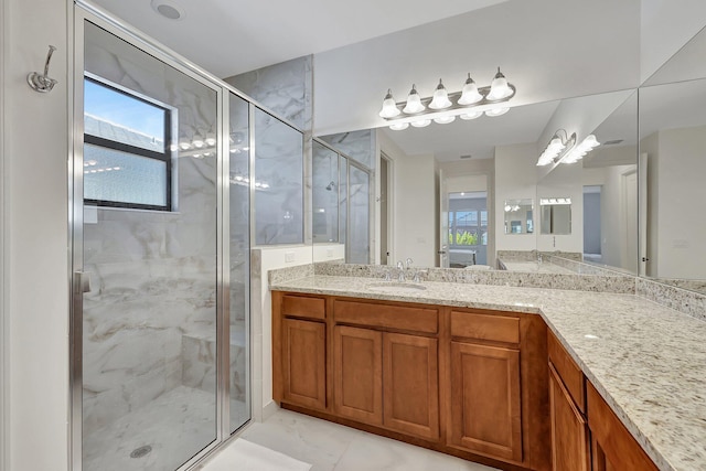 bathroom featuring tile patterned floors, plenty of natural light, vanity, and an enclosed shower