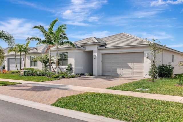 view of front facade featuring a front yard and a garage