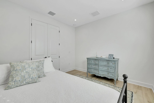 bedroom with hardwood / wood-style flooring and a closet