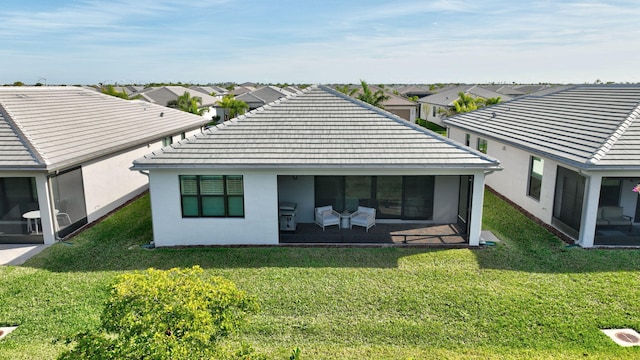 rear view of house featuring a lawn