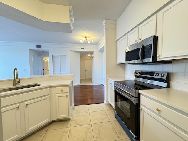 kitchen with white cabinetry, sink, black range with electric cooktop, crown molding, and light tile patterned floors