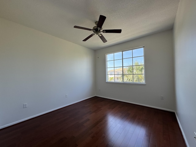 spare room featuring ceiling fan, dark hardwood / wood-style flooring, and a textured ceiling