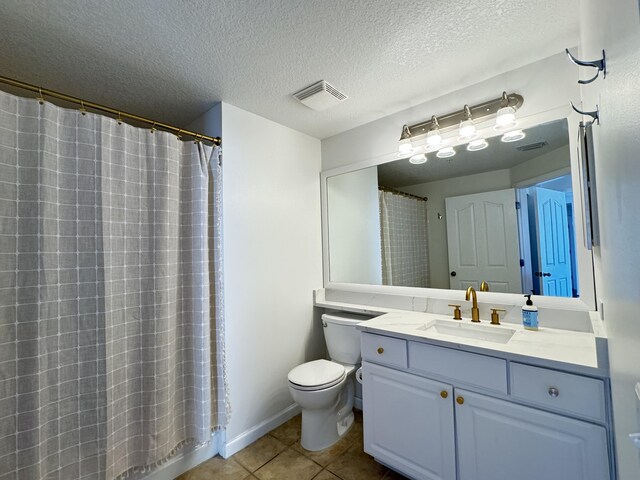 bathroom with a shower with curtain, tile patterned floors, a textured ceiling, toilet, and vanity