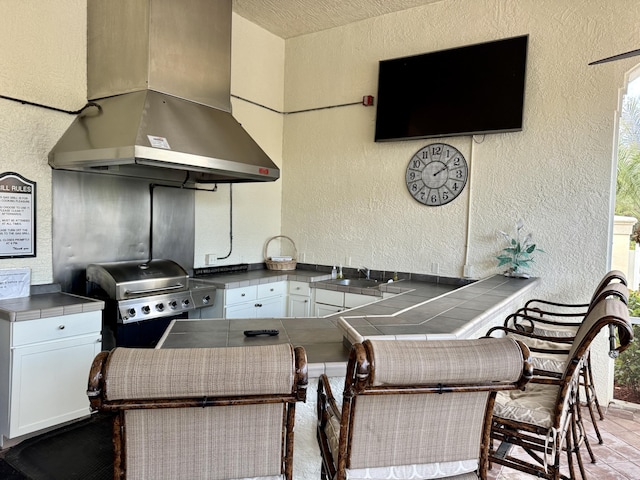 view of patio / terrace featuring area for grilling, sink, and grilling area