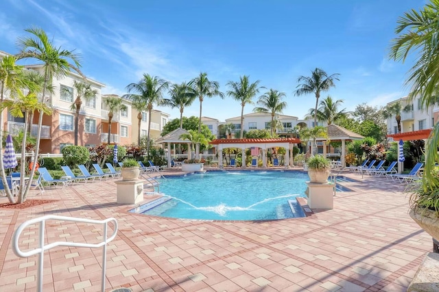 view of pool with a gazebo, pool water feature, and a patio