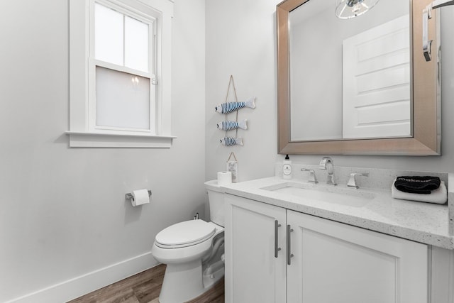 bathroom featuring hardwood / wood-style floors, vanity, and toilet