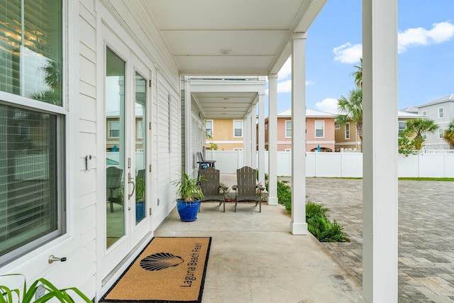 view of patio featuring a porch and french doors