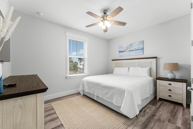 bedroom with hardwood / wood-style floors and ceiling fan