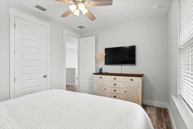 bedroom with ceiling fan and hardwood / wood-style floors