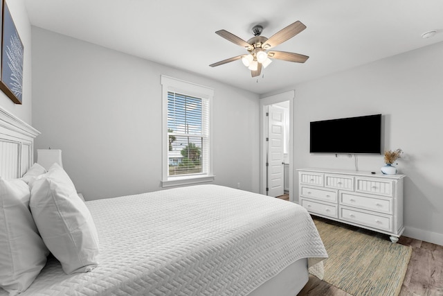 bedroom with wood-type flooring and ceiling fan