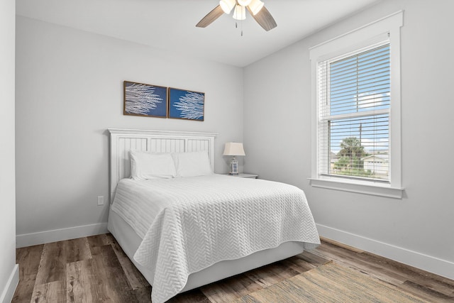 bedroom featuring multiple windows, ceiling fan, and hardwood / wood-style flooring