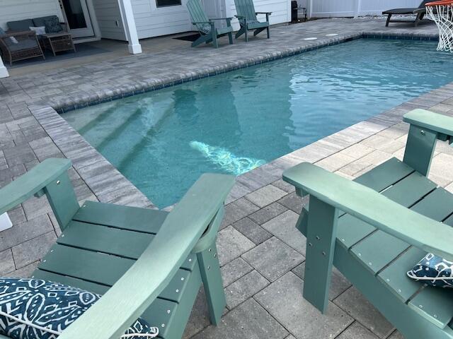 view of swimming pool with an outdoor living space and a patio