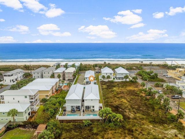 drone / aerial view with a water view and a view of the beach