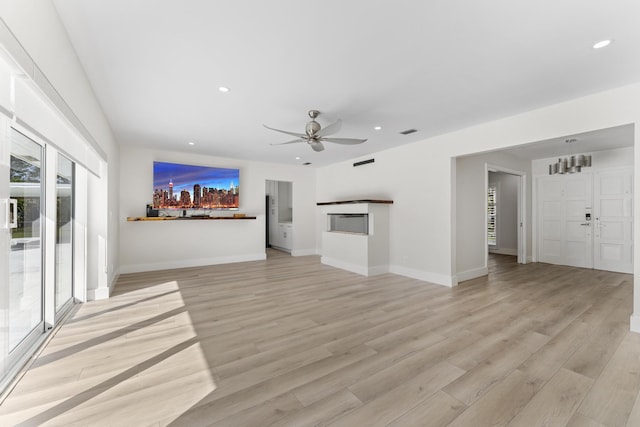 unfurnished living room with light hardwood / wood-style floors and ceiling fan