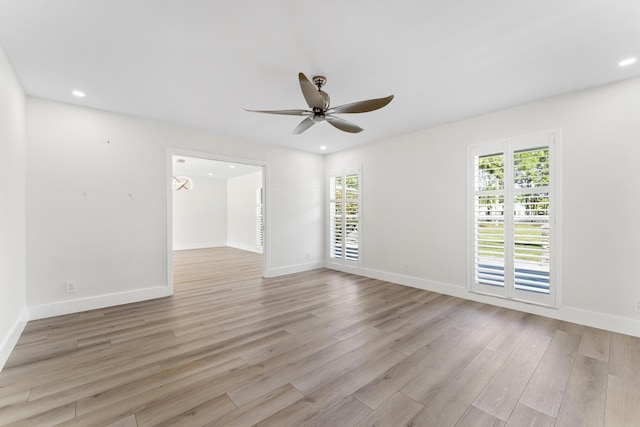 unfurnished room with ceiling fan, plenty of natural light, and light hardwood / wood-style flooring