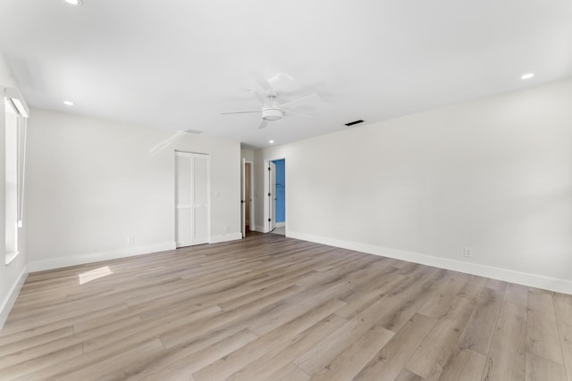 empty room featuring ceiling fan and light wood-type flooring