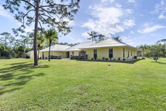 rear view of house with a yard