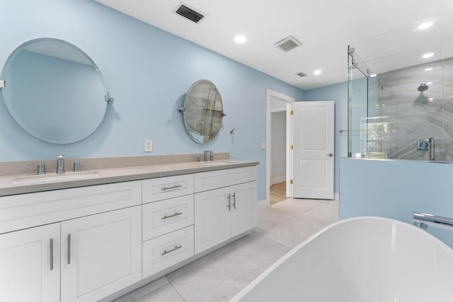 bathroom featuring tile patterned floors, vanity, and shower with separate bathtub