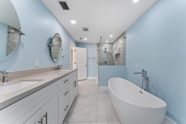 bathroom featuring plus walk in shower, vanity, and tile patterned floors