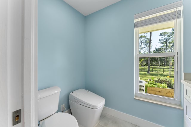 bathroom with tile patterned flooring, vanity, and toilet