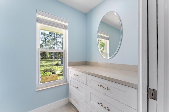 walk in closet with light tile patterned floors