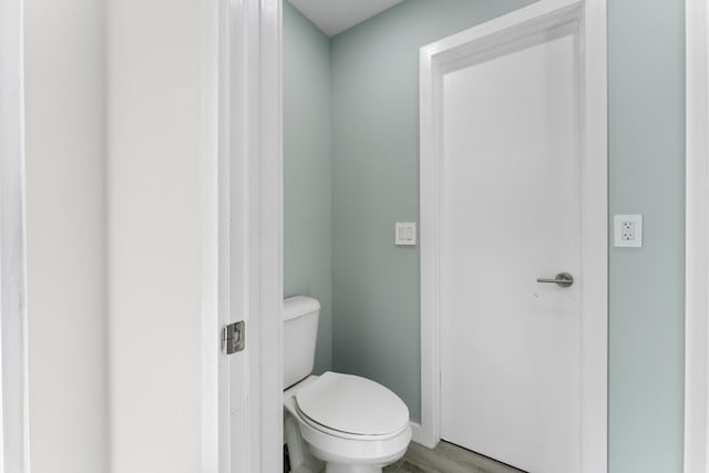 bathroom featuring hardwood / wood-style floors and toilet