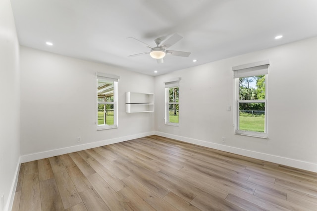 unfurnished room with ceiling fan, light hardwood / wood-style floors, and a wealth of natural light