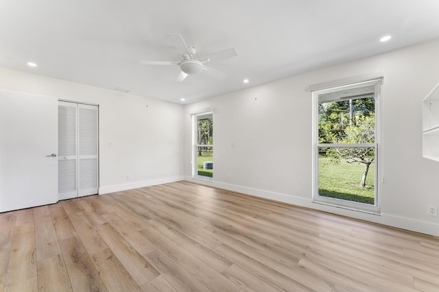 spare room with ceiling fan and light hardwood / wood-style floors