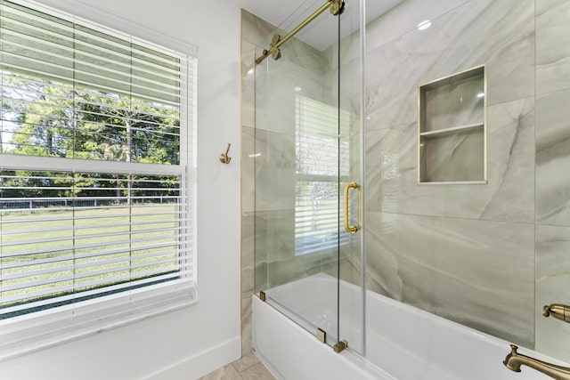 bathroom featuring shower / bath combination with glass door and tile patterned flooring