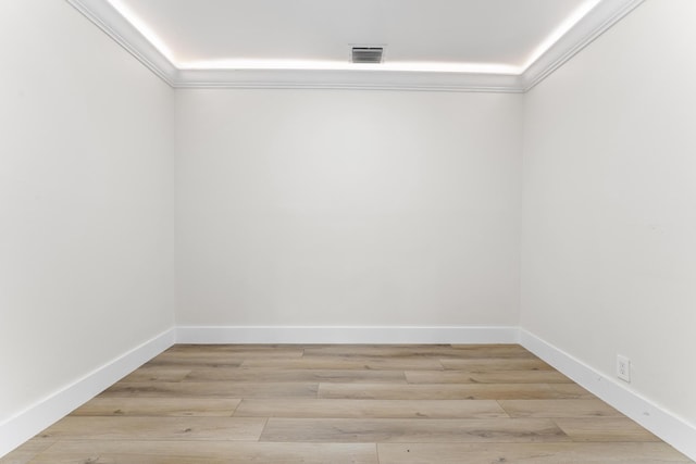 spare room with light hardwood / wood-style floors and ornamental molding