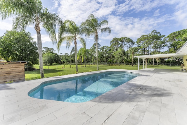 view of pool featuring a lawn and a patio