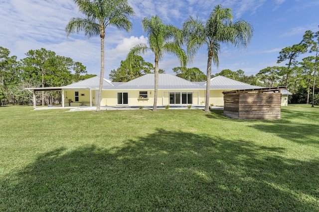 rear view of house with a lawn