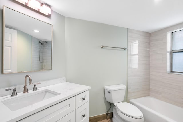 full bathroom with vanity, toilet, and tiled shower / bath combo