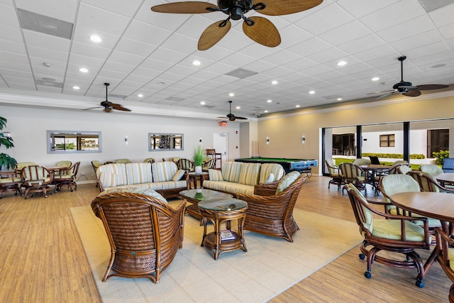 living room featuring a wealth of natural light, ornamental molding, light wood-type flooring, and billiards