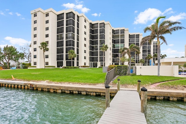 view of dock featuring a yard and a water view