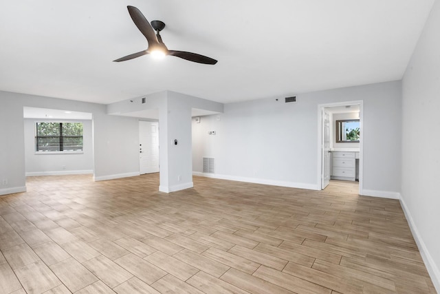 unfurnished living room featuring ceiling fan