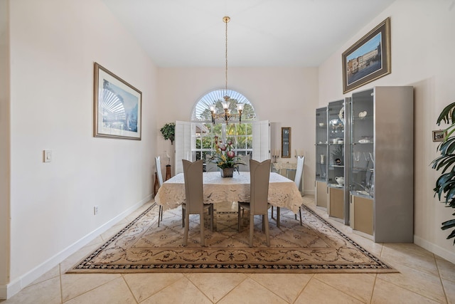 dining space with tile patterned flooring and a chandelier