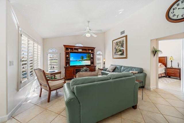 tiled living room featuring ceiling fan and vaulted ceiling