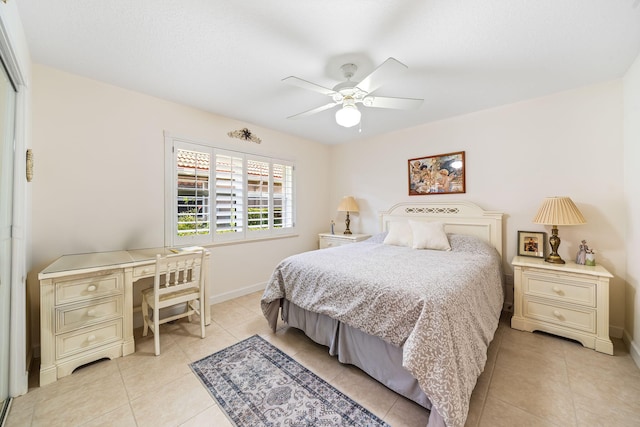 tiled bedroom featuring ceiling fan