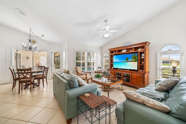 tiled living room with ceiling fan with notable chandelier and vaulted ceiling