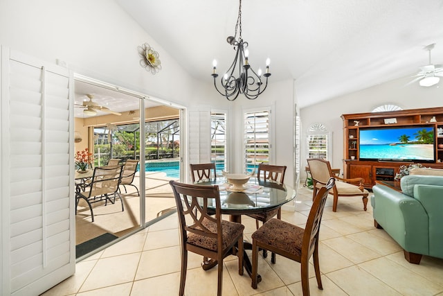 tiled dining room featuring plenty of natural light, ceiling fan with notable chandelier, and vaulted ceiling