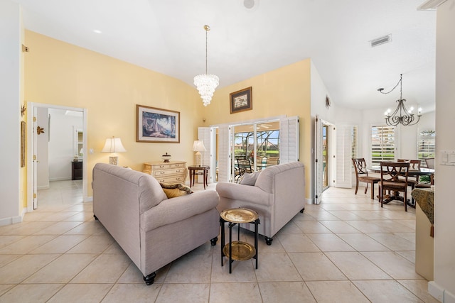 living room featuring light tile patterned flooring and an inviting chandelier