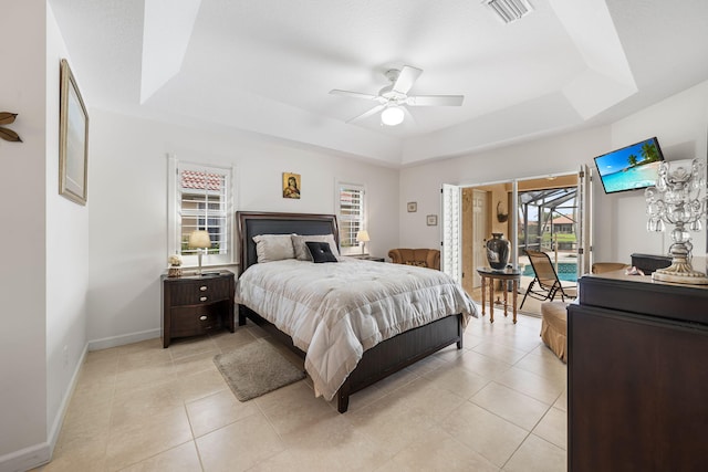 tiled bedroom with access to outside, a tray ceiling, and ceiling fan