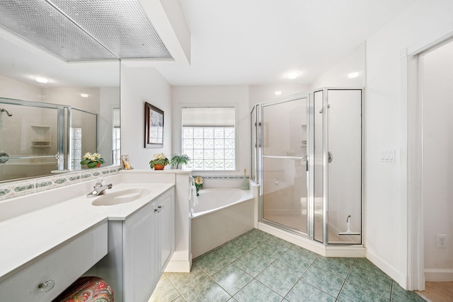 bathroom featuring tile patterned flooring, vanity, and shower with separate bathtub