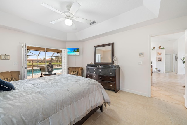 tiled bedroom featuring access to outside, a raised ceiling, and ceiling fan